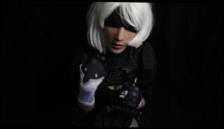 Watch the video about Silicone doll with 2B cosplay gives blowjob to strapon