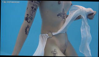 Watch the video about Cutest tattooed teen Mimi swimming naked