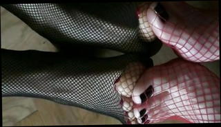 Watch the video about Double foot play in fishnet stockings