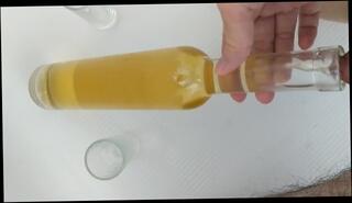 Watch the video about Filling up a wine bottle and two small glasses with piss