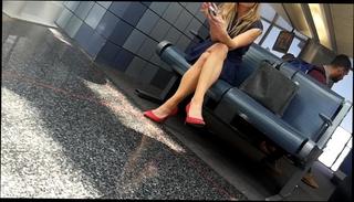 Watch the video about Candid legs and feet in red heels at airport