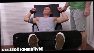 Watch the video about Muscled jock Sebastian gets brush tickled in his feet