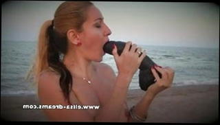 Watch the video about Naked and dirty with my huge black sextoy on the beach