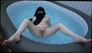 Watch the video about Naked in Niqab Getting wet in the Hot Tub showing off pussy, Bum and breasts