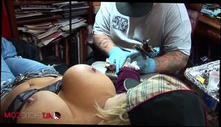 Watch the video about Shyla Stylez gets tattooed while playing with her tits