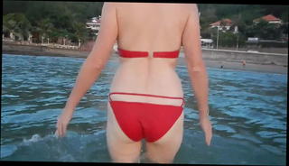 Watch the video about Wife at the beach in red bikini (naked wife)