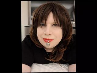 Watch the video about Sissy Kelli walks a hotel corridor wearing a penis gag