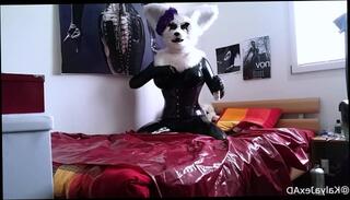 Watch the video about Kalya the rubber furry lube her big latex boobs